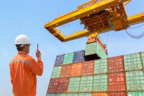 Man working in container harbor