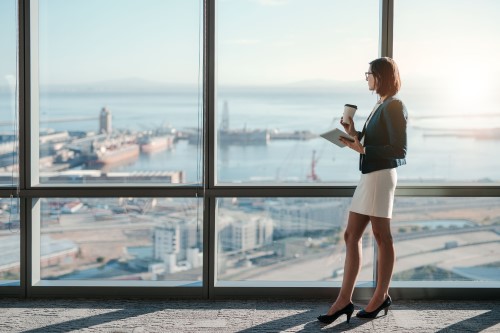 Woman standing before harbour